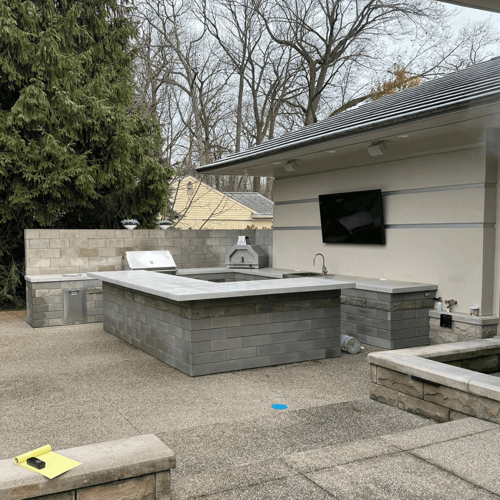 backyard before pergola installation with outdoor kitchen area