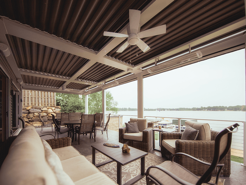 A complete outdoor living project with louvered pergola, motorized screens, radiant heaters, outdoor kitchen, bi-fold doors, and a custom elevated patio in Chelsea, MI built and designed by Skyview Detroit.