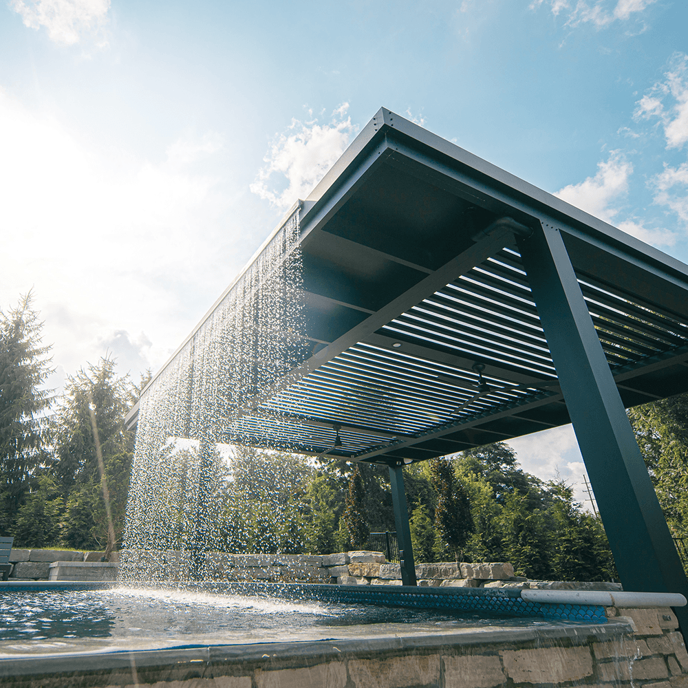 Unique StruXure louvered pergola with custom water rain feature in South Lyon MI by Skyview Detroit