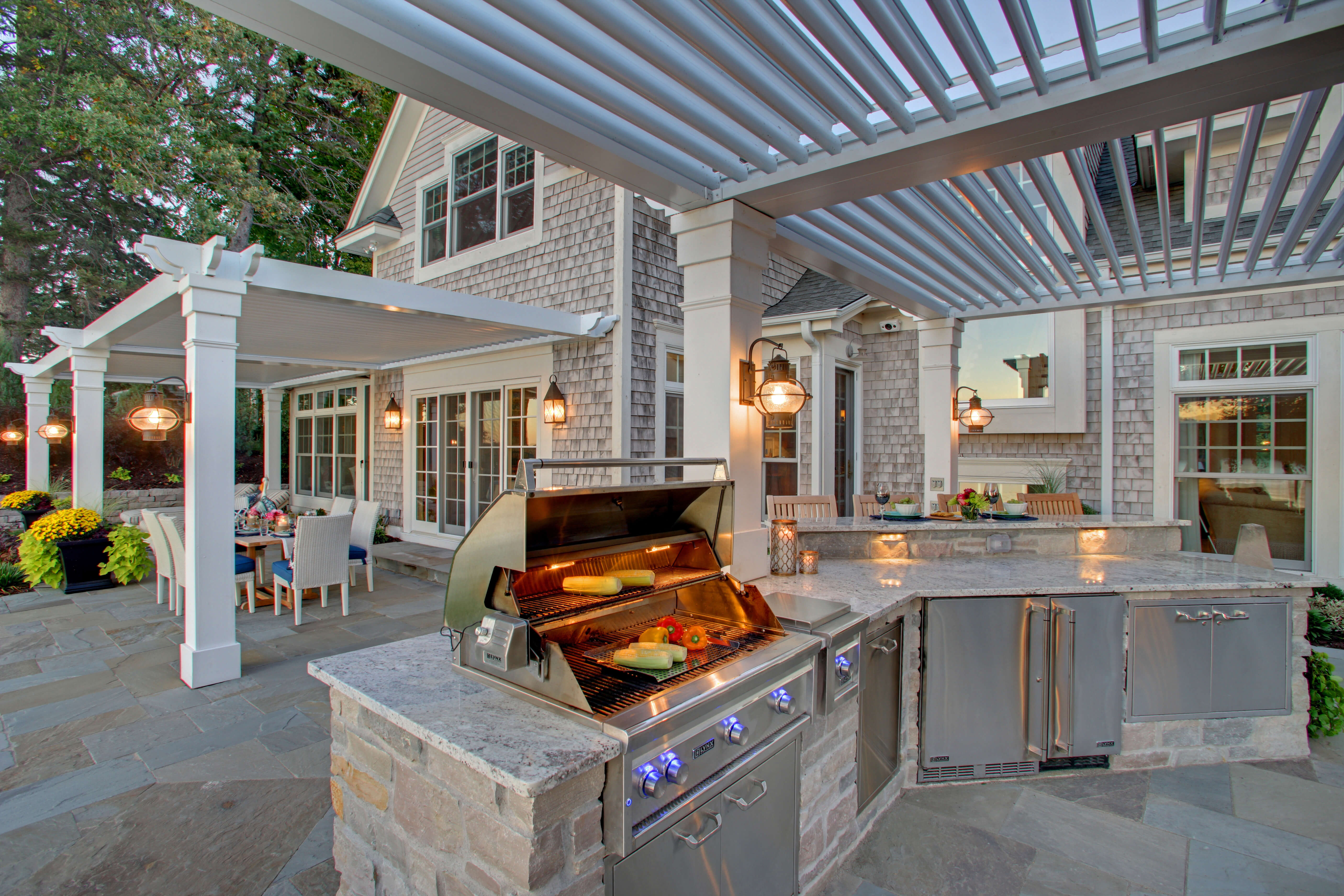 Luxurious backyard with louvered pergola and outdoor kitchen setup