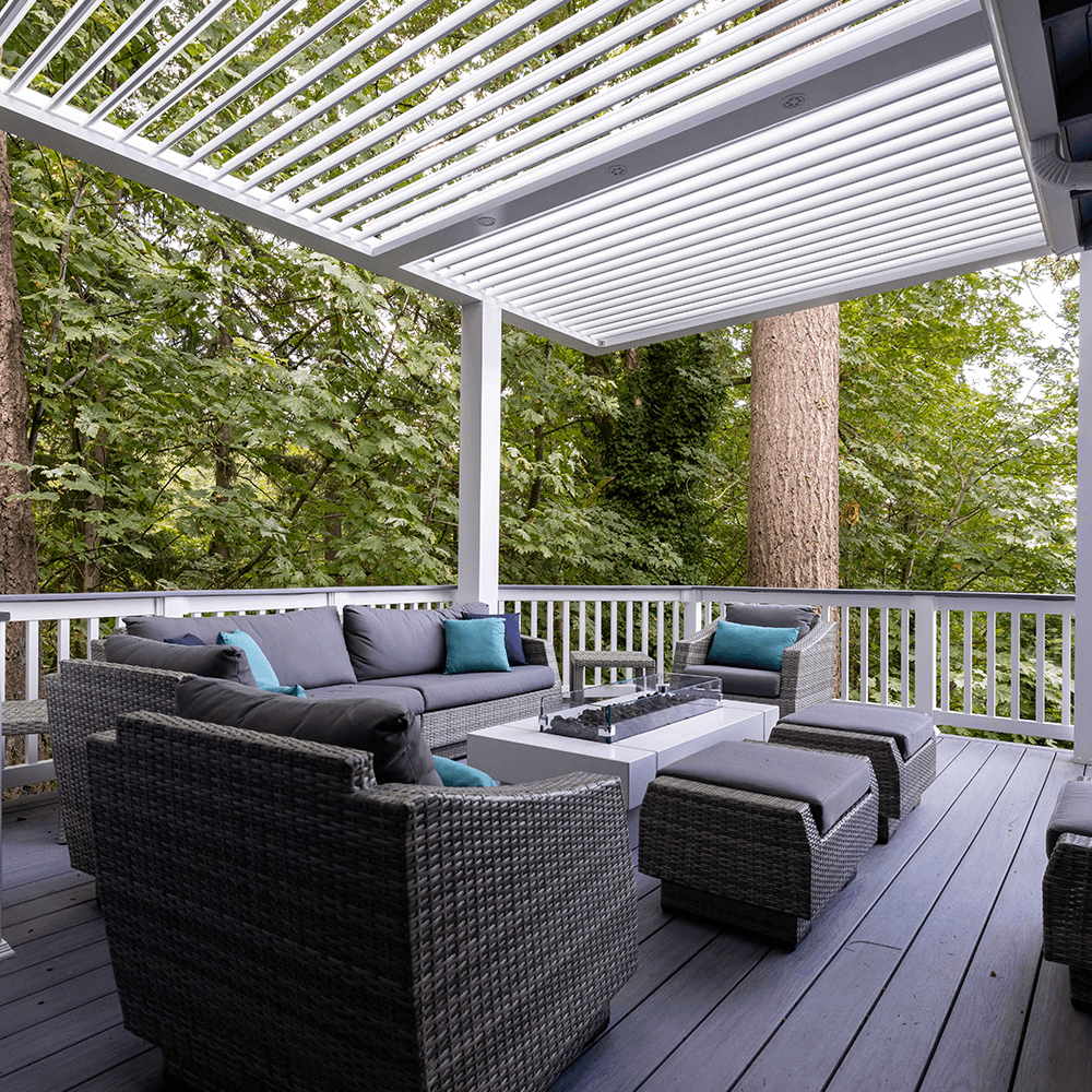 StruXure louvered pergola on TimberTech PVC deck in wooded environment