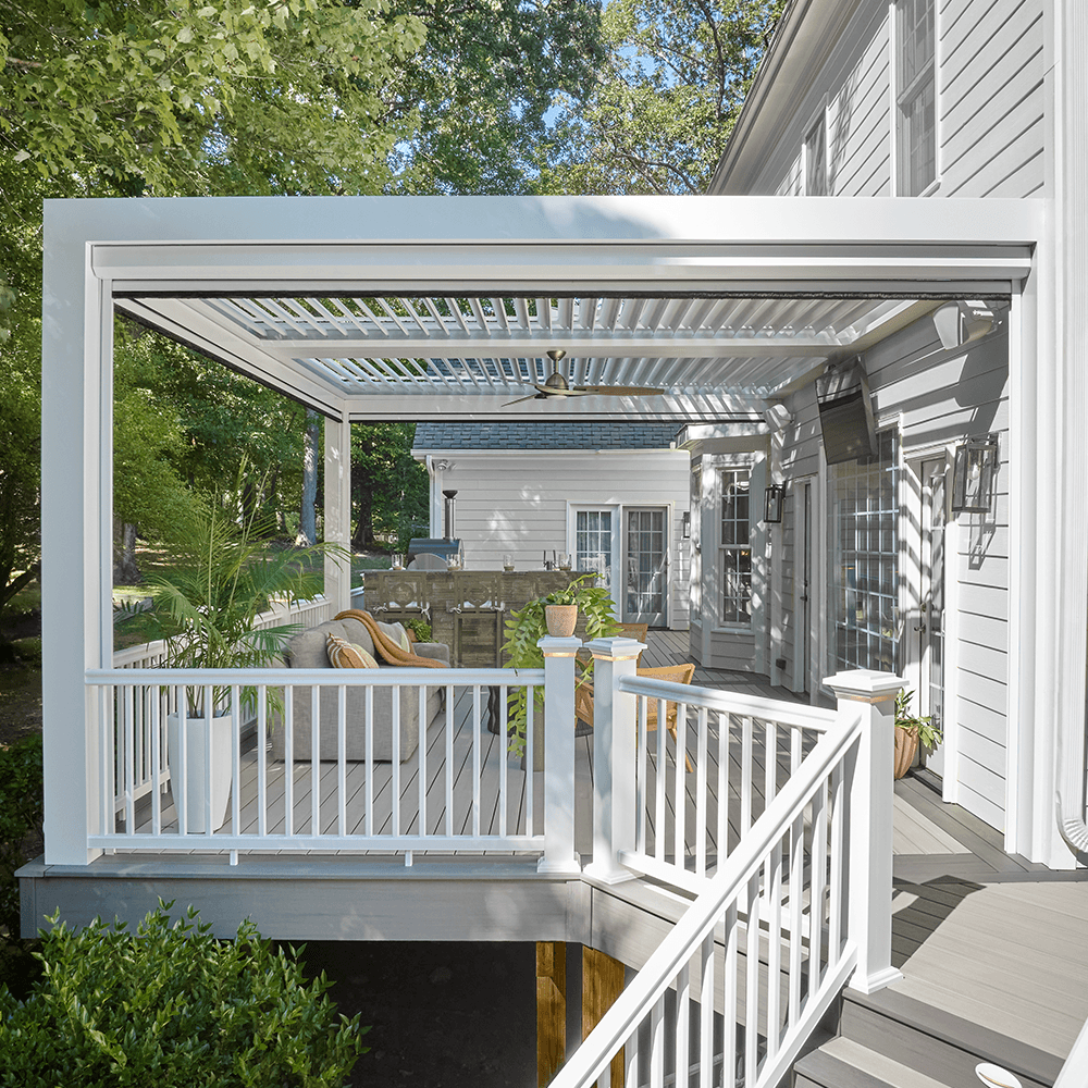 StruXure louvered pergola on TimberTech PVC deck in wooded environment