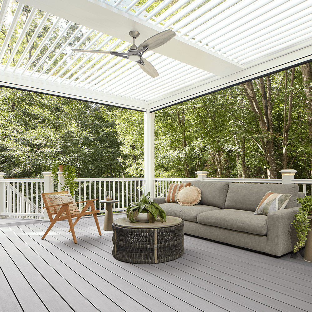 StruXure louvered pergola on TimberTech PVC deck in wooded environment