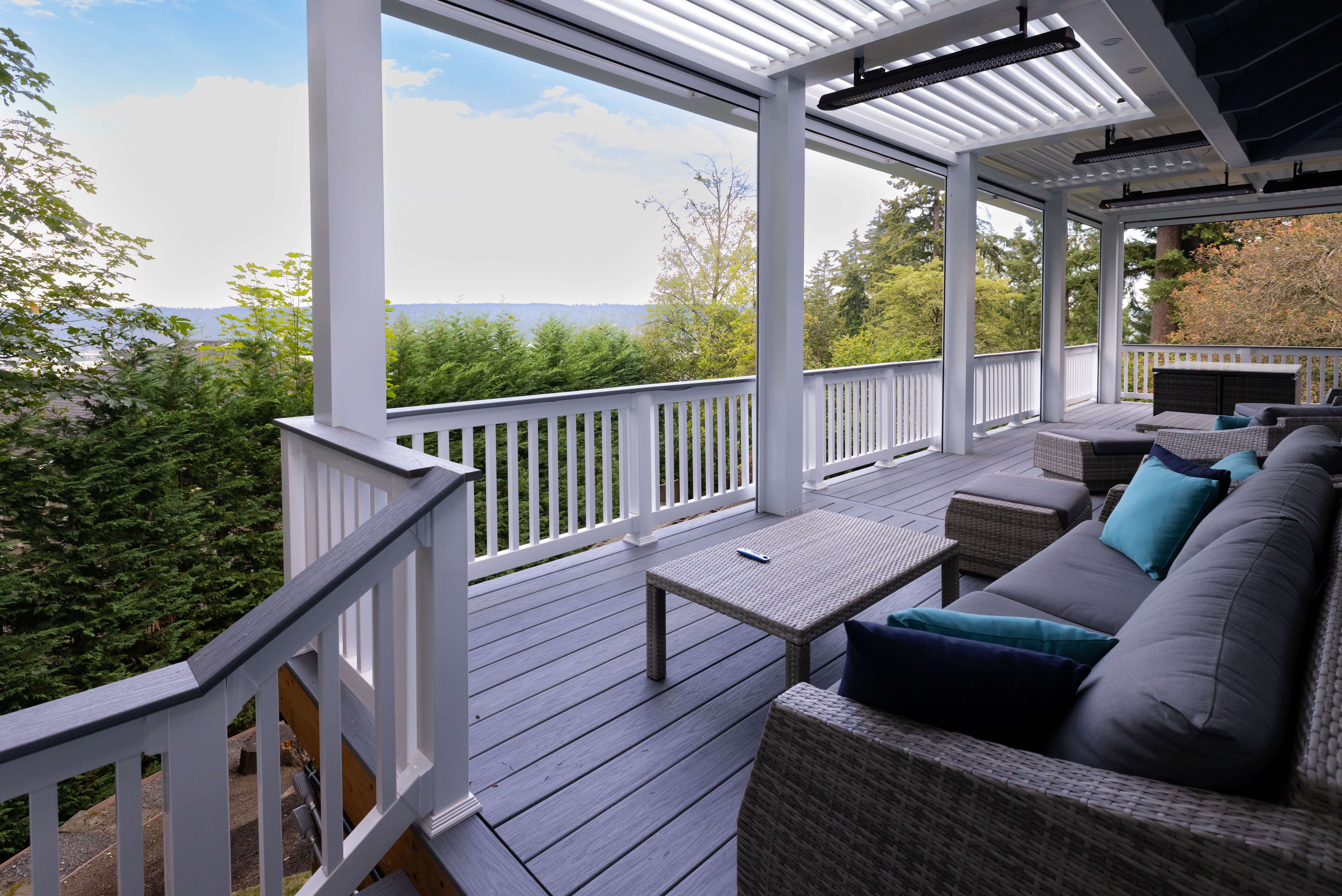 StruXure pergola with screen on elevated deck in wooded environment
