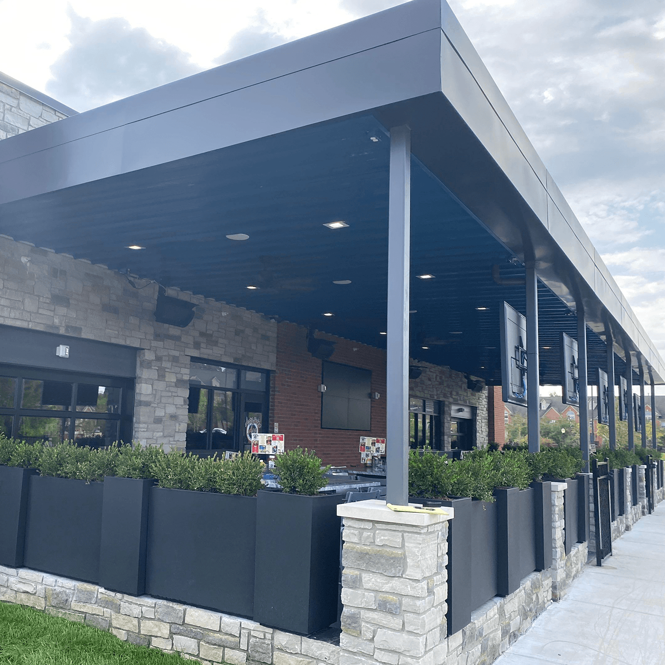 covered restaurant patio before MagnaTrack screen installation in Northville Township Michigan