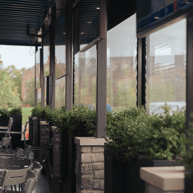restaurant patio with sun-blocking screen borders during evening hours