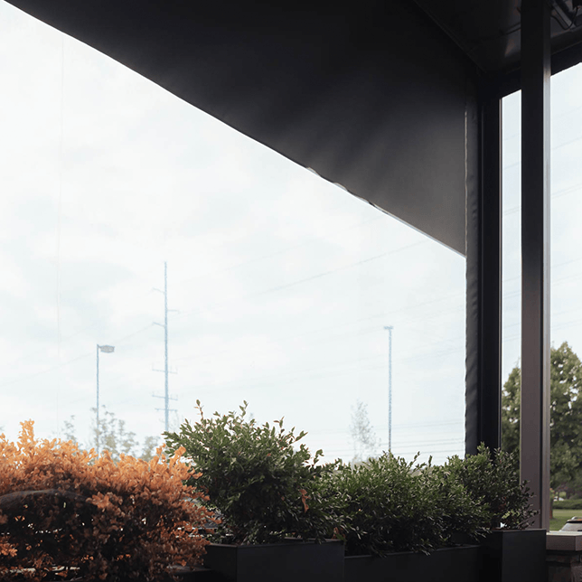 restaurant patio with sun-blocking screen borders during evening hours