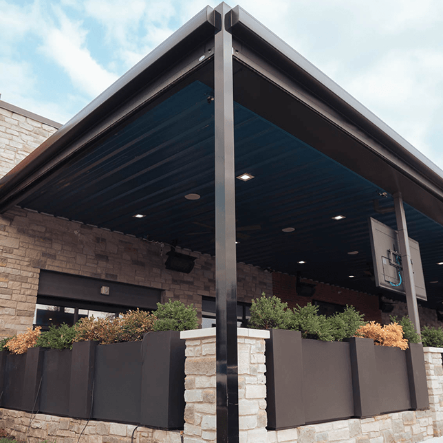 restaurant patio with sun-blocking screen borders during evening hours