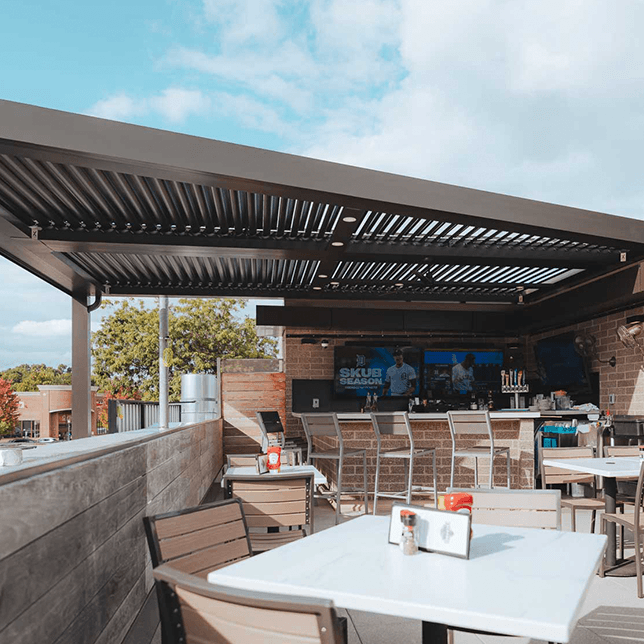 StruXure pergola rooftop bar with integrated lighting and fans