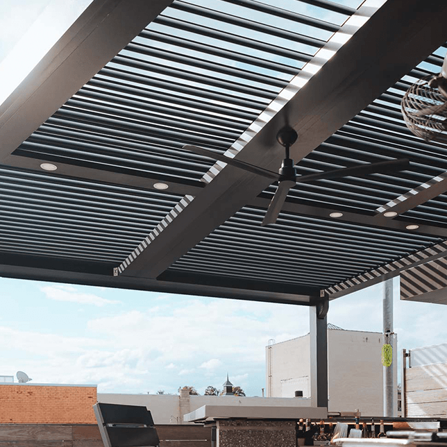 StruXure pergola rooftop bar with integrated lighting and fans