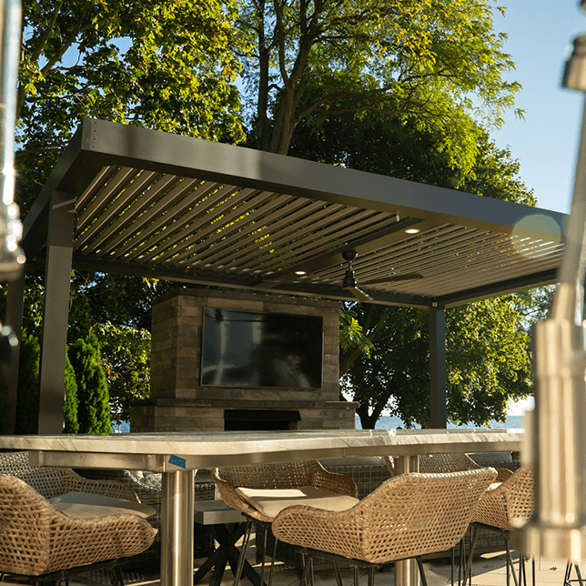 Modern waterfront patio with pergola and seating area