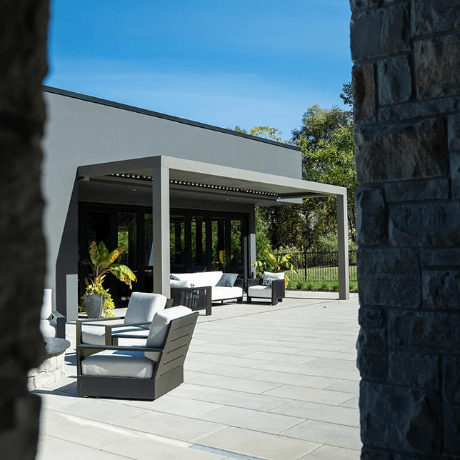 Manual crank louvered pergola providing adjustable shade