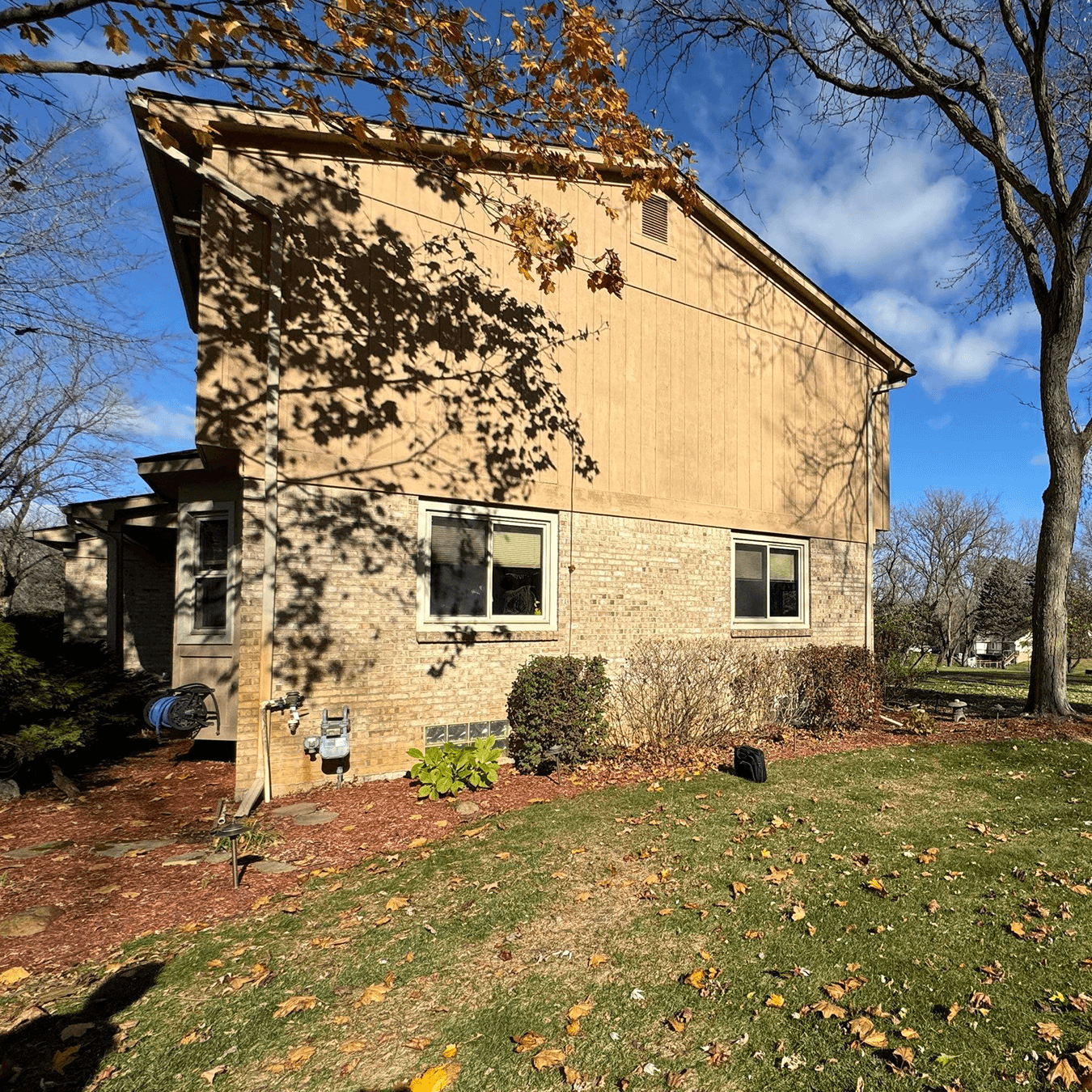 Rear exterior of home before sunroom addition in Milford Michigan