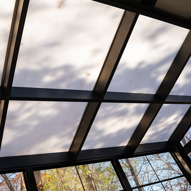 Outdoor retreat with polycarbonate roof and natural surroundings