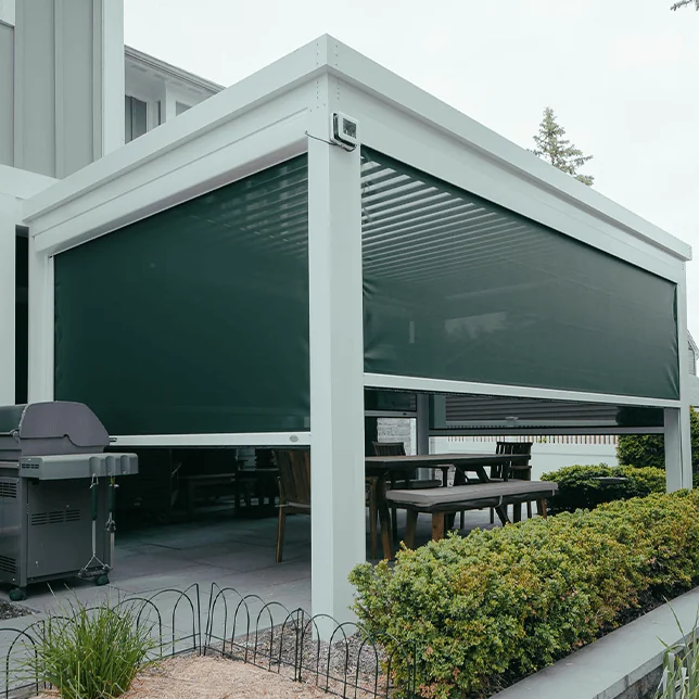 Outdoor residential patio featuring modern furniture set under an adjustable louvered pergola, surrounded by lush greenery and a tidy lawn, presenting a comfortable and stylish setting for dining and relaxation.